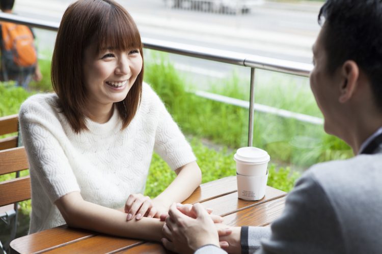 A couple talking on happy cafe terrace